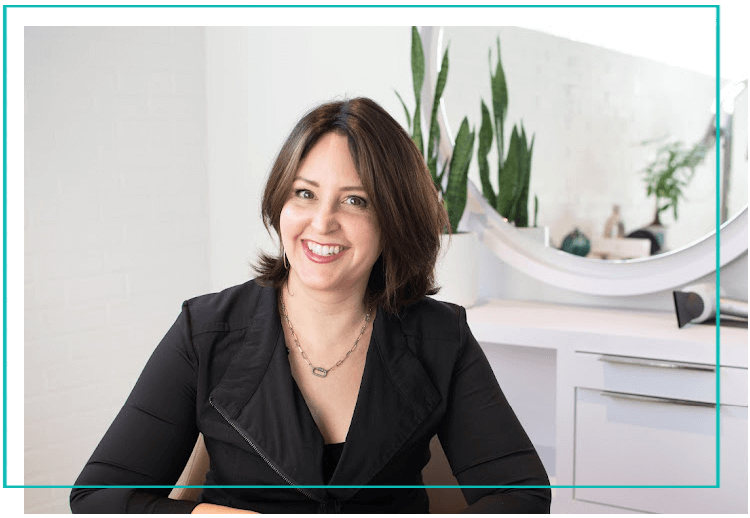 Lisa Ferestad smiles in her salon, Cura Hair Solutions